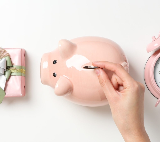 piggy-bank-hand-with-coin-gift-box-clock-white-background-top-view-1-scaled-1