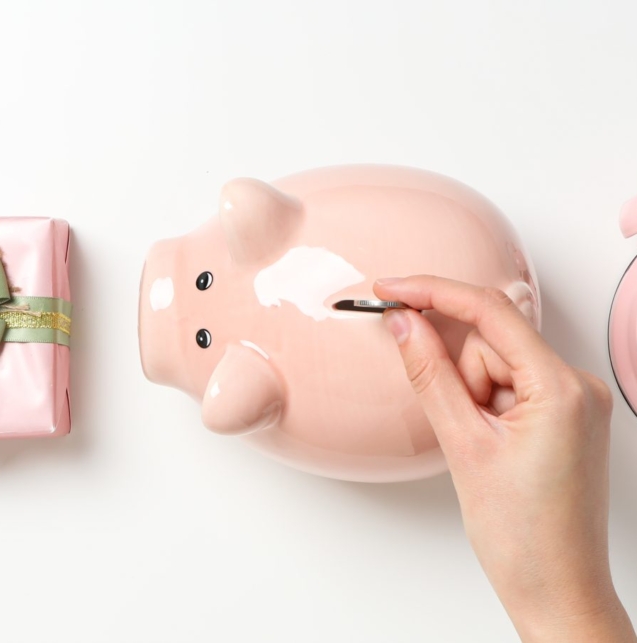 piggy-bank-hand-with-coin-gift-box-clock-white-background-top-view-1-scaled-1